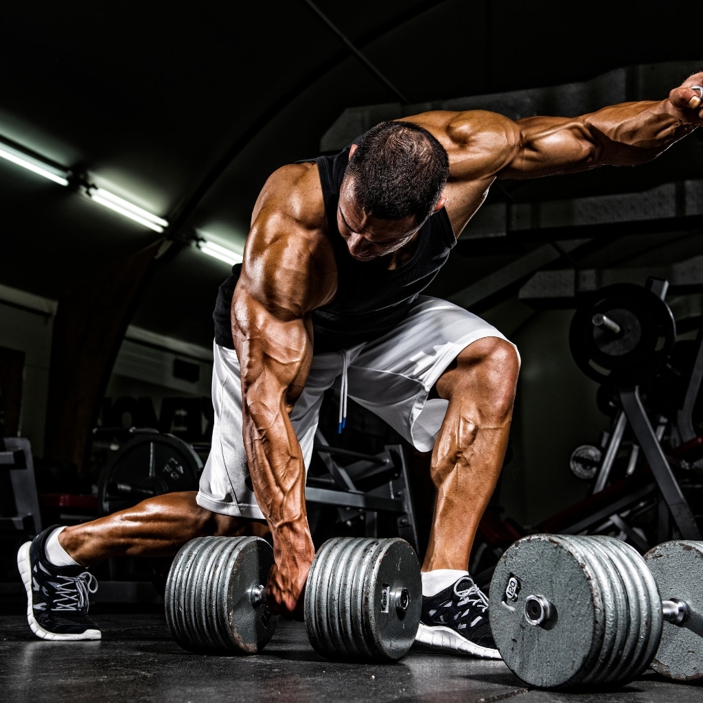 Athlete performing workout splits for rapid muscle gain in gym setting