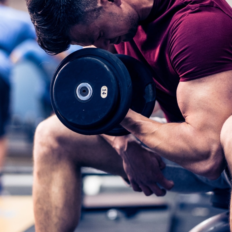 Man looking concerned at his increased body fat while trying to bulk up during his fitness journey